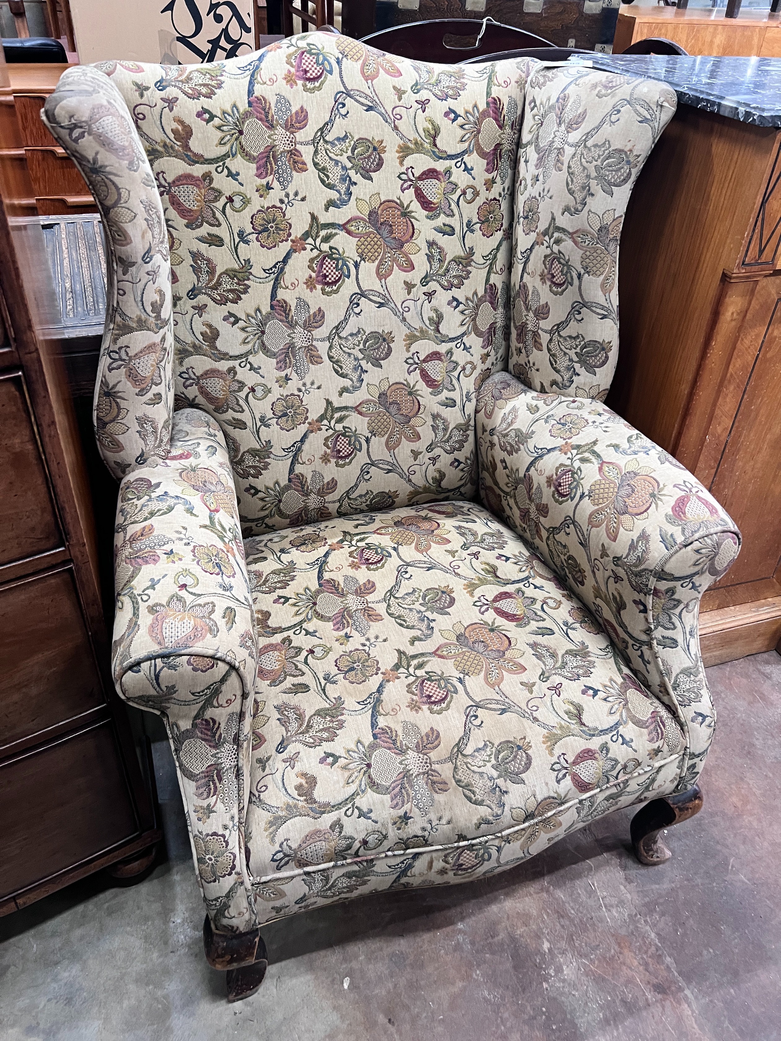 An early 18th century style mahogany wing armchair, width 78cm *Please note the sale commences at 9am.